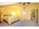 Bright bedroom boasts plush carpeting and a bed with vibrant floral bedding, creating a cozy and inviting atmosphere at 7691 Heritage Crossing Way # C-1, Reunion, FL 34747