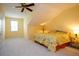 Bright bedroom features plush carpeting and a bed with vibrant floral bedding, creating a cozy and inviting atmosphere at 7691 Heritage Crossing Way # C-1, Reunion, FL 34747