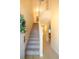 Bright entryway with staircase, features neutral color palette, and tiled floors at 7691 Heritage Crossing Way # C-1, Reunion, FL 34747