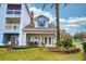 Charming vacation rental features a porch with outdoor seating, ideal for relaxing and enjoying the surroundings at 7691 Heritage Crossing Way # C-1, Reunion, FL 34747