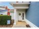 Inviting front door with a decorative wreath, and a welcome mat at the front entry at 7691 Heritage Crossing Way # C-1, Reunion, FL 34747