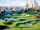 Beautiful golf course with manicured greens, sand traps, and resort residences in the background at 7691 Heritage Crossing Way # C-1, Reunion, FL 34747