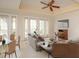 Bright living room boasts hardwood floors, a ceiling fan and sliding glass doors to a balcony at 7691 Heritage Crossing Way # C-1, Reunion, FL 34747