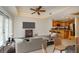 Spacious condo living room open to the kitchen, featuring hardwood floors and modern decor at 7691 Heritage Crossing Way # C-1, Reunion, FL 34747