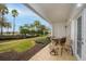 Covered patio with comfortable seating and lush landscaping at 7691 Heritage Crossing Way # C-1, Reunion, FL 34747