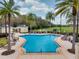 Inviting pool with poolside seating area and view of lush golf course at 7691 Heritage Crossing Way # C-1, Reunion, FL 34747