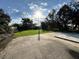 Expansive backyard with lush lawn, mature trees, and a concrete pad at 803 N Pine Hills Rd, Orlando, FL 32808