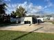 Spacious backyard features a concrete patio, lush green grass, and a secure fence at 803 N Pine Hills Rd, Orlando, FL 32808