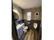 Charming half bathroom with modern fixtures, round mirror, and brick accent wall at 803 N Pine Hills Rd, Orlando, FL 32808