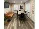 Contemporary dining room with modern table, comfortable seating, and a large wall-mounted TV at 803 N Pine Hills Rd, Orlando, FL 32808