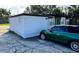 Cozy single-story home features a white exterior, black trim and green front door at 803 N Pine Hills Rd, Orlando, FL 32808