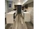 Modern kitchen area with sleek white countertops, a brick wall, and an industrial feel at 803 N Pine Hills Rd, Orlando, FL 32808