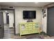 Modern living room with a light green dresser and a large flat-screen TV at 803 N Pine Hills Rd, Orlando, FL 32808