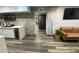 Inviting living room features modern flooring, exposed brick, and a stylish kitchenette at 803 N Pine Hills Rd, Orlando, FL 32808