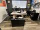 Modern office space with a concrete-style desk, ergonomic chair, and ample storage at 803 N Pine Hills Rd, Orlando, FL 32808