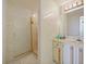 Elegant bathroom featuring marble walls, vanity with sink, walk-in shower and mirrored wall at 901 S Atlantic Ave # 5, Ormond Beach, FL 32176