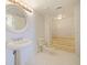 Bathroom with marble floor and walls featuring a pedestal sink and a bathtub at 901 S Atlantic Ave # 5, Ormond Beach, FL 32176