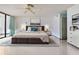 Spacious bedroom with a large bed, neutral colors, and access to a private balcony at 901 S Atlantic Ave # 5, Ormond Beach, FL 32176
