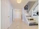 Elegant foyer with marble floors, chandelier lighting, grand staircase, and soft blue wall accents at 901 S Atlantic Ave # 5, Ormond Beach, FL 32176
