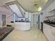 Spacious kitchen with white cabinets, modern appliances, marble countertops, and easy access to stairs and laundry room at 901 S Atlantic Ave # 5, Ormond Beach, FL 32176