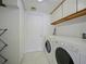 Well-lit laundry room with full size washer and dryer, ample storage, and a clean, organized space at 901 S Atlantic Ave # 5, Ormond Beach, FL 32176