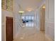 A bright living room with an ocean view and marble floors leads to stairs at 901 S Atlantic Ave # 5, Ormond Beach, FL 32176