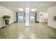 Lobby area with tile floors, multiple elevators, and greenery at 901 S Atlantic Ave # 5, Ormond Beach, FL 32176