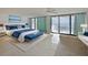 Bright main bedroom features tile floors, balcony access, and a seating area with ocean views at 901 S Atlantic Ave # 5, Ormond Beach, FL 32176