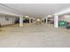 Parking garage featuring a concrete floor, open parking spaces and equipment storage at 901 S Atlantic Ave # 5, Ormond Beach, FL 32176