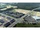 An aerial view of a modern apartment complex and shopping center in a planned community at 9338 Bolshoi Aly, Winter Garden, FL 34787