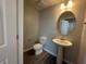 Cozy powder room featuring a pedestal sink, toilet, and tiled flooring at 9338 Bolshoi Aly, Winter Garden, FL 34787