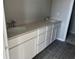 Bathroom featuring double sinks with quartz countertops and ample cabinet space at 9338 Bolshoi Aly, Winter Garden, FL 34787