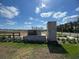 Entrance to the Tribute at Ovation community with stacked stone sign and landscaping at 9338 Bolshoi Aly, Winter Garden, FL 34787