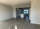Open-concept living space featuring wood-look tile flooring and seamless transition to the modern kitchen at 9338 Bolshoi Aly, Winter Garden, FL 34787