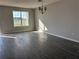 Well-lit living room featuring gray wood-look flooring and a view of the neighborhood through the window at 9338 Bolshoi Aly, Winter Garden, FL 34787