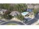 Aerial shot of community pool, clubhouse, playground, and parking lot surrounded by lush greenery and residential homes at 9575 Silver Buttonwood St, Orlando, FL 32832