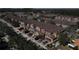 Aerial view of a residential street with well-maintained townhomes and front-yard parking at 9575 Silver Buttonwood St, Orlando, FL 32832