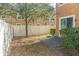 View of the backyard from a corner view showing the partial fence and a small outdoor space at 9575 Silver Buttonwood St, Orlando, FL 32832