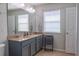 Bathroom with a double sink vanity, mirror, and tiled floor at 9575 Silver Buttonwood St, Orlando, FL 32832