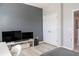 Bedroom with a dark gray accent wall and a entertainment center at 9575 Silver Buttonwood St, Orlando, FL 32832