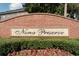 Nona Preserve brick community sign surrounded by vibrant green bushes and colorful flowers at 9575 Silver Buttonwood St, Orlando, FL 32832