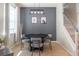 Modern dining room with a stylish table, gray accent wall, and nearby staircase at 9575 Silver Buttonwood St, Orlando, FL 32832