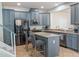 Beautiful kitchen featuring gray cabinets, stainless steel appliances, and a center island with bar stool seating at 9575 Silver Buttonwood St, Orlando, FL 32832