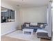 Inviting living room with a comfortable sofa, soft rug, and open access to the kitchen at 9575 Silver Buttonwood St, Orlando, FL 32832