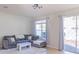 Cozy living room with comfortable seating, tile floors, and natural light from the sliding doors at 9575 Silver Buttonwood St, Orlando, FL 32832