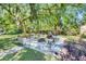 Inviting backyard patio with ample seating surrounding a fire pit, perfect for outdoor gatherings at 980 Oleander Se Dr, Winter Haven, FL 33880