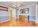 Dining room with parquet floors, traditional furniture, and stylish lighting fixture at 980 Oleander Se Dr, Winter Haven, FL 33880