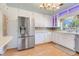 Bright kitchen featuring white cabinets, stainless steel appliances, and modern refrigerator at 980 Oleander Se Dr, Winter Haven, FL 33880