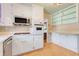 Bright kitchen with white cabinetry and stainless steel oven and microwave at 980 Oleander Se Dr, Winter Haven, FL 33880