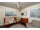 Cozy Bedroom features hardwood floors, neutral walls, a ceiling fan and bright windows at 1021 Carlson Dr, Orlando, FL 32804